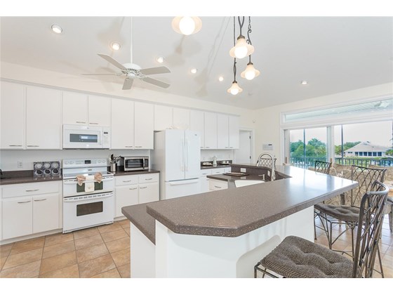 Kitchen and Breakfast Bar. - Single Family Home for sale at 62 Tarpon Way, Placida, FL 33946 - MLS Number is D6121925