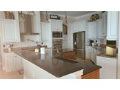 The kitchen is light and bright with plenty of countertop workspace. - Single Family Home for sale at 1900 Illinois Ave, Englewood, FL 34224 - MLS Number is D6121965