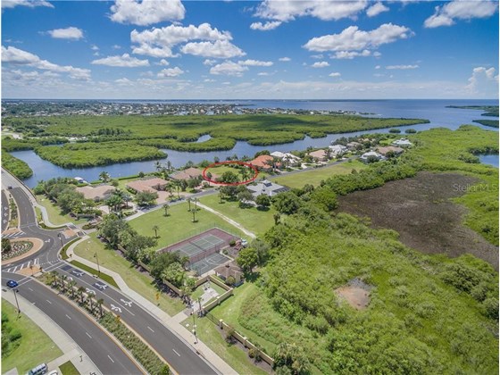 Parcel #4 in the private subdivision of Lea Marie Island, looking from the Northwest. Private tennis courts, basketball court and playground are in the forground of this picture. - Vacant Land for sale at 4030 Lea Marie Island Dr, Port Charlotte, FL 33952 - MLS Number is C7404124