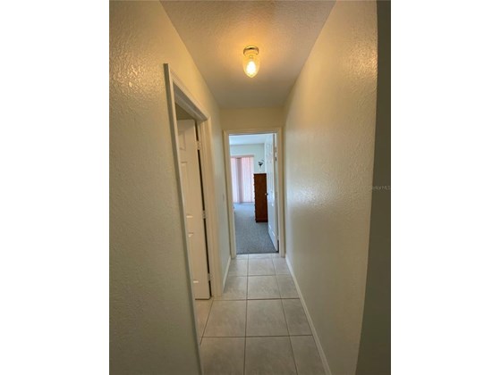 Down the hallway is the 2nd bedroom. To the left where you see the opening will lead into the guest bathroom. - Single Family Home for sale at 18506 Hottelet Cir, Port Charlotte, FL 33948 - MLS Number is C7452138
