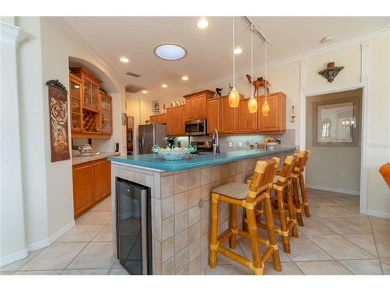 Kitchen with Skylight and under counter Wine Cooler. Pocket door on right to Bedroom 2 and 3 with Bathroom provide a complete private suite. - Single Family Home for sale at 6521 Sundew Ct, Lakewood Ranch, FL 34202 - MLS Number is A4514104