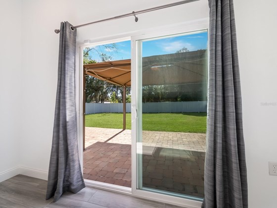 Sliding glass doors from primary bedroom provide easy access to patio. - Single Family Home for sale at 3070 Hatton St, Sarasota, FL 34237 - MLS Number is A4518301