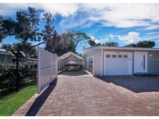 Secure parking pad features an automatic solar powered gate. - Single Family Home for sale at 3070 Hatton St, Sarasota, FL 34237 - MLS Number is A4518301