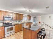 Kitchen with breakfast bar - Single Family Home for sale at 5227 Siesta Cove Dr, Sarasota, FL 34242 - MLS Number is A4519271